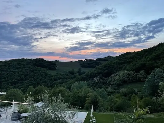 Panoramic evening view of the Langhe hills from Borgo Isolabella, Loazzolo, Piemonte — VEDA Ayurvedic Wellness location